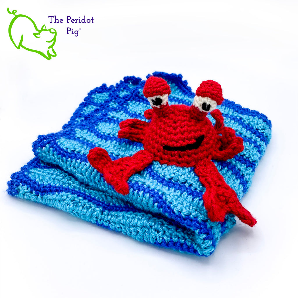 Cliff the Crab is featured on this cute security blanket! Some think he can be a bit terse but he's really the life of the party. Those eyes pop up and just seem to say, "Hellloooooo!" He's hanging out in the waves of a bright blue, Caribbean ocean.  He's made of 100% high, quality acrylic yarn for a really durable blanket. He's sewn onto the blanket which measures 17x18". Perfect for a beach house or an Under the Sea themed room! Front view shown.