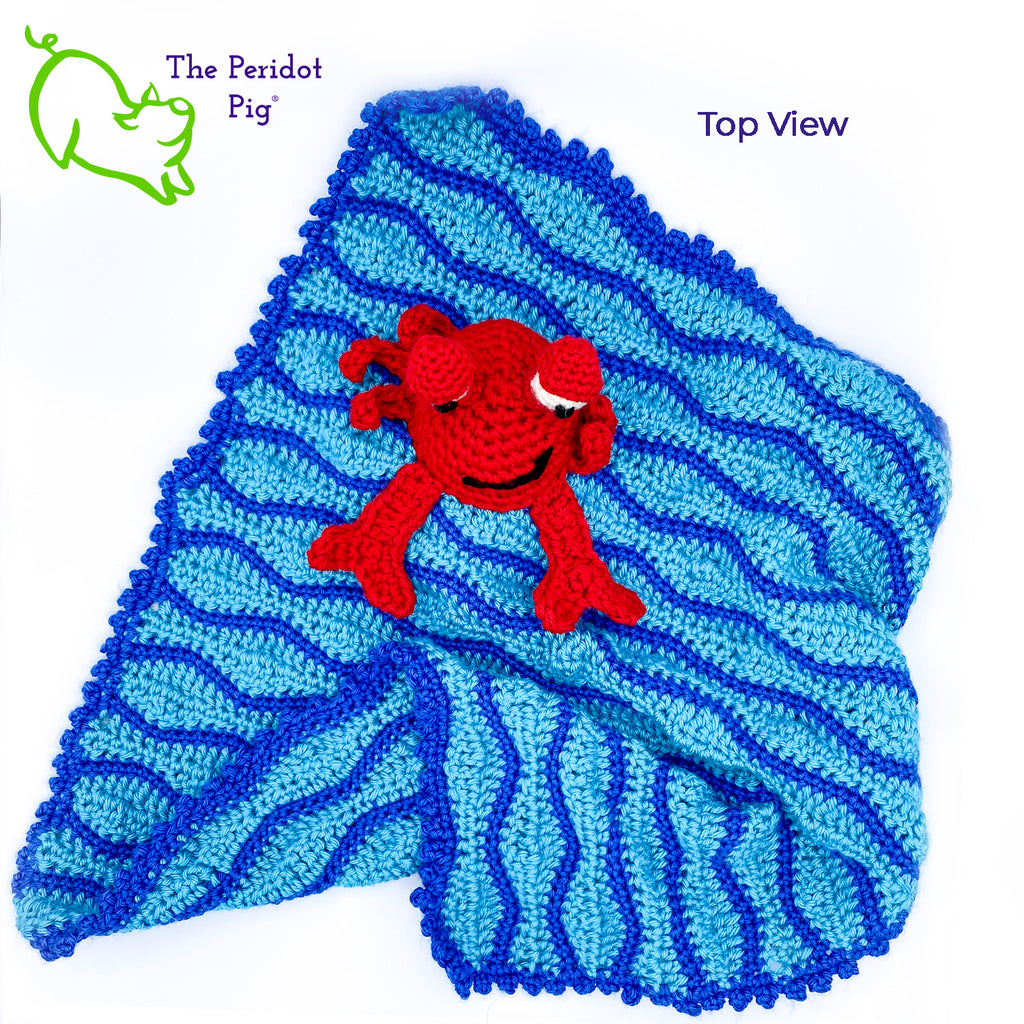 Cliff the Crab is featured on this cute security blanket! Some think he can be a bit terse but he's really the life of the party. Those eyes pop up and just seem to say, "Hellloooooo!" He's hanging out in the waves of a bright blue, Caribbean ocean.  He's made of 100% high, quality acrylic yarn for a really durable blanket. He's sewn onto the blanket which measures 17x18". Perfect for a beach house or an Under the Sea themed room! Top view shown.