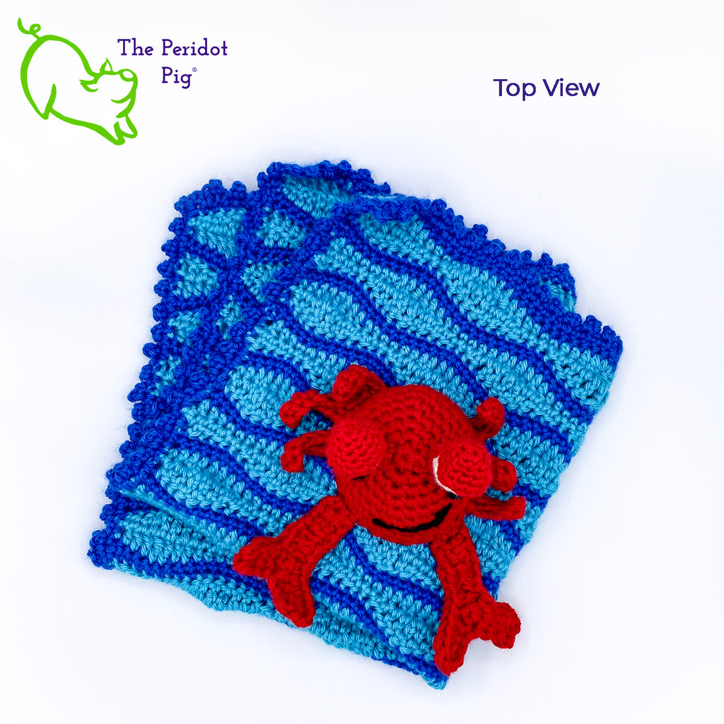 Cliff the Crab is featured on this cute security blanket! Some think he can be a bit terse but he's really the life of the party. Those eyes pop up and just seem to say, "Hellloooooo!" He's hanging out in the waves of a bright blue, Caribbean ocean.  He's made of 100% high, quality acrylic yarn for a really durable blanket. He's sewn onto the blanket which measures 17x18". Perfect for a beach house or an Under the Sea themed room! Top view shown.