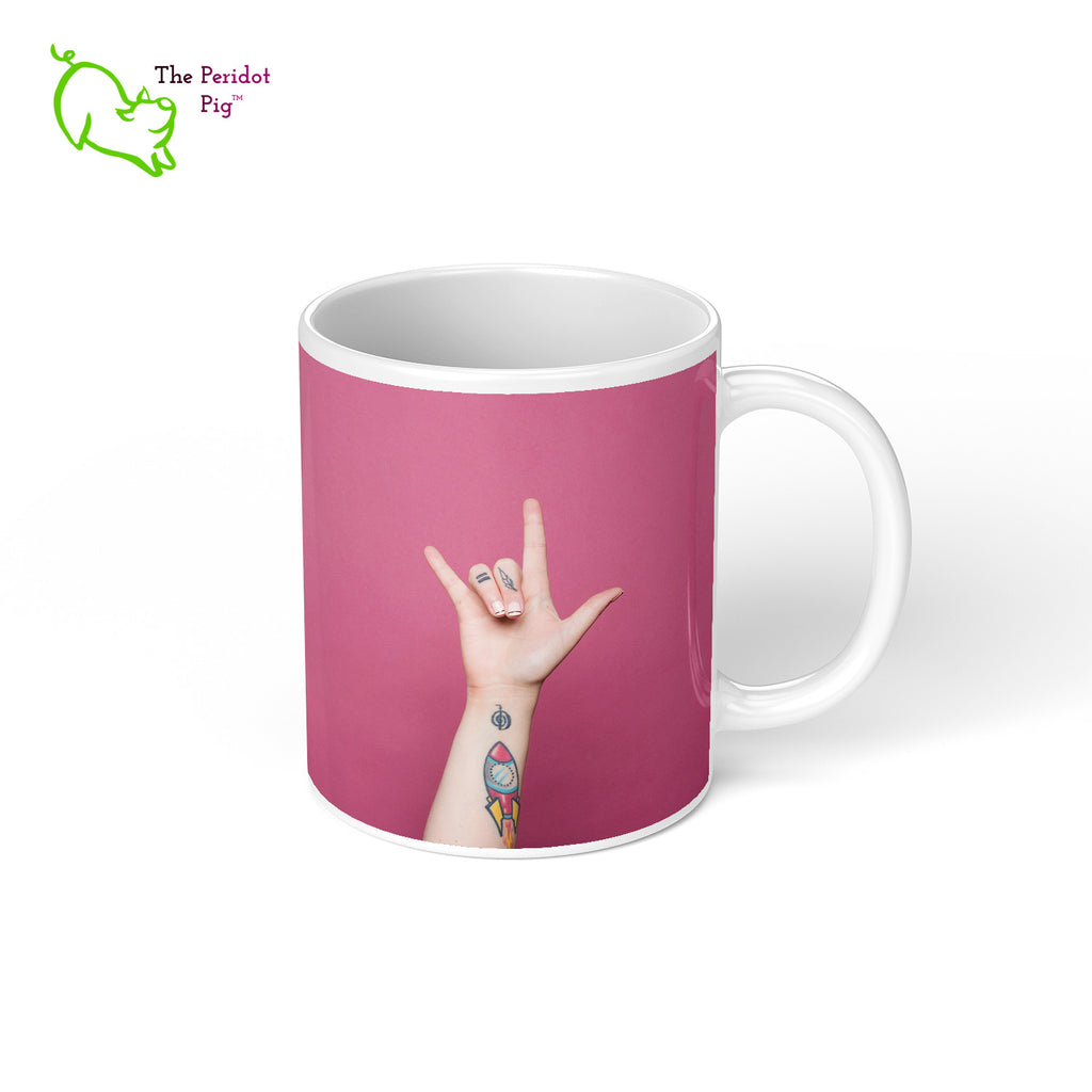 Our 11 oz coffee mug has the printed phrase, "Love You, Mean It" one one side and the raised hand on the other spelling "I love you" in ASL. Right view.