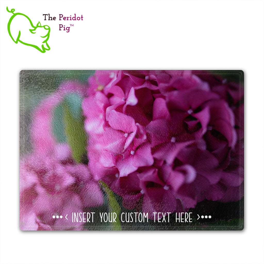 These beautiful tempered glass cutting boards are a wonderful keepsake!  They can be personalized with names, quotes or dates. This one features bright purple pink hydrangeas in a vivid and detailed print. Perfect for cutting or using as a serving board! Fron view.