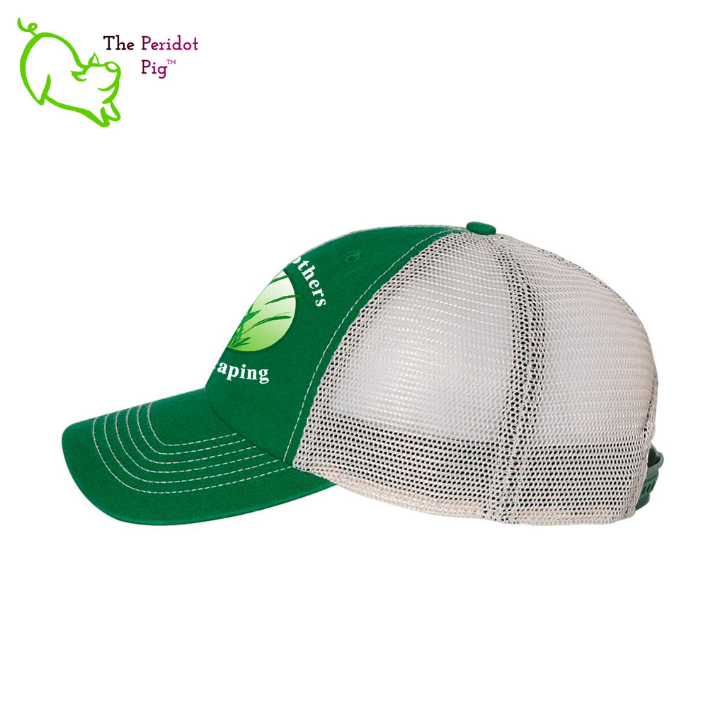 The perfect hat if you're out in the sun and weather all day. Shade in the front and cool mesh in the back. This hat features the Zako Brothers company logo and the words, "Zako Brothers Landscaping" in white lettering. Side view.