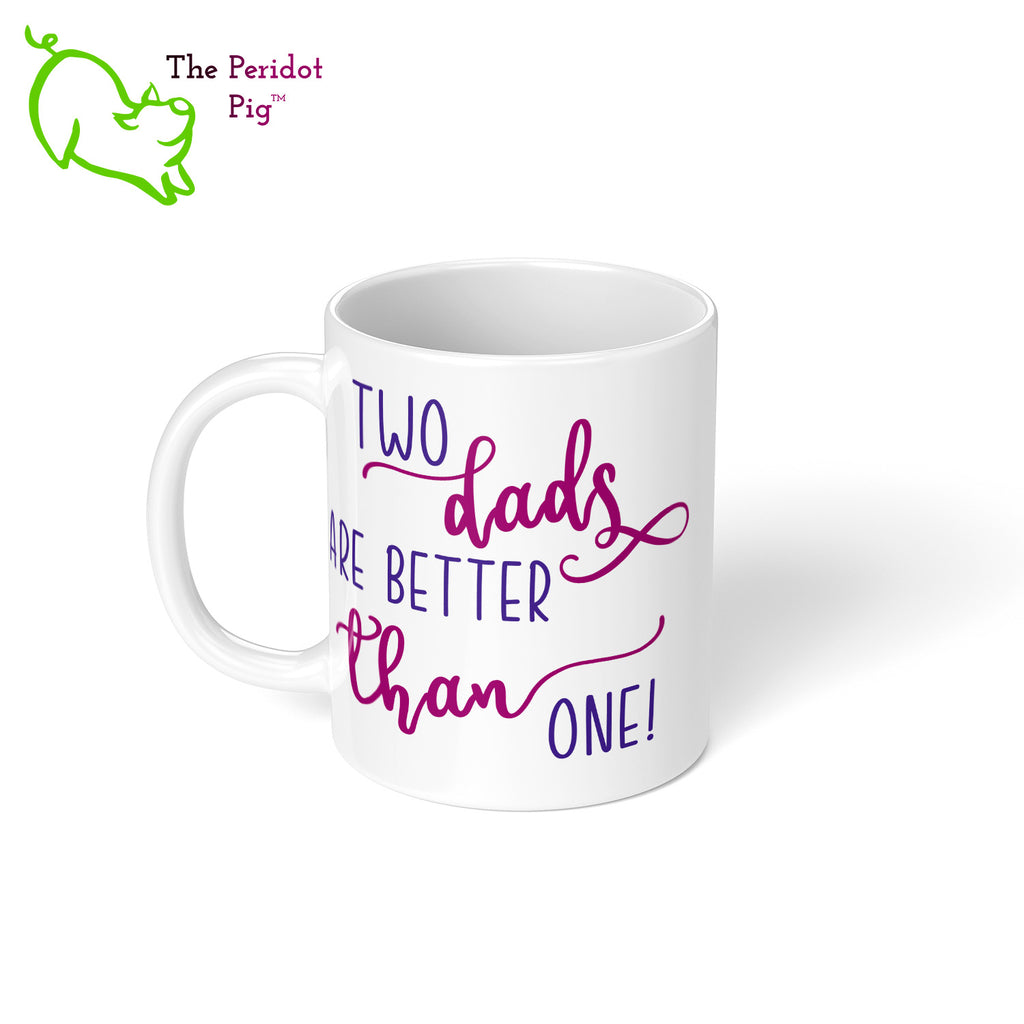 A shout out to our LGTQBA Dads! Celebrate Father's day with a gift that embraces your pride. The mug says, "Two dads are better than one!" on the front. On the back, it has rainbow stripes with the saying, "Love is love".  Left view.