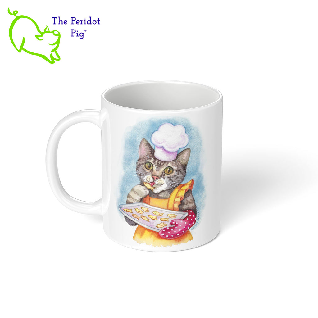 This 11 oz ceramic mug features the colorful artwork of Cathy Pavia and would be the perfect gift for a cat lover or chef. You have a cool cooking kitty on the front, baking some little kitty snacks. They're dressed in a bright apron, chef's hat and a polka dot oven mitt. On the back is the same image. Shown left view.