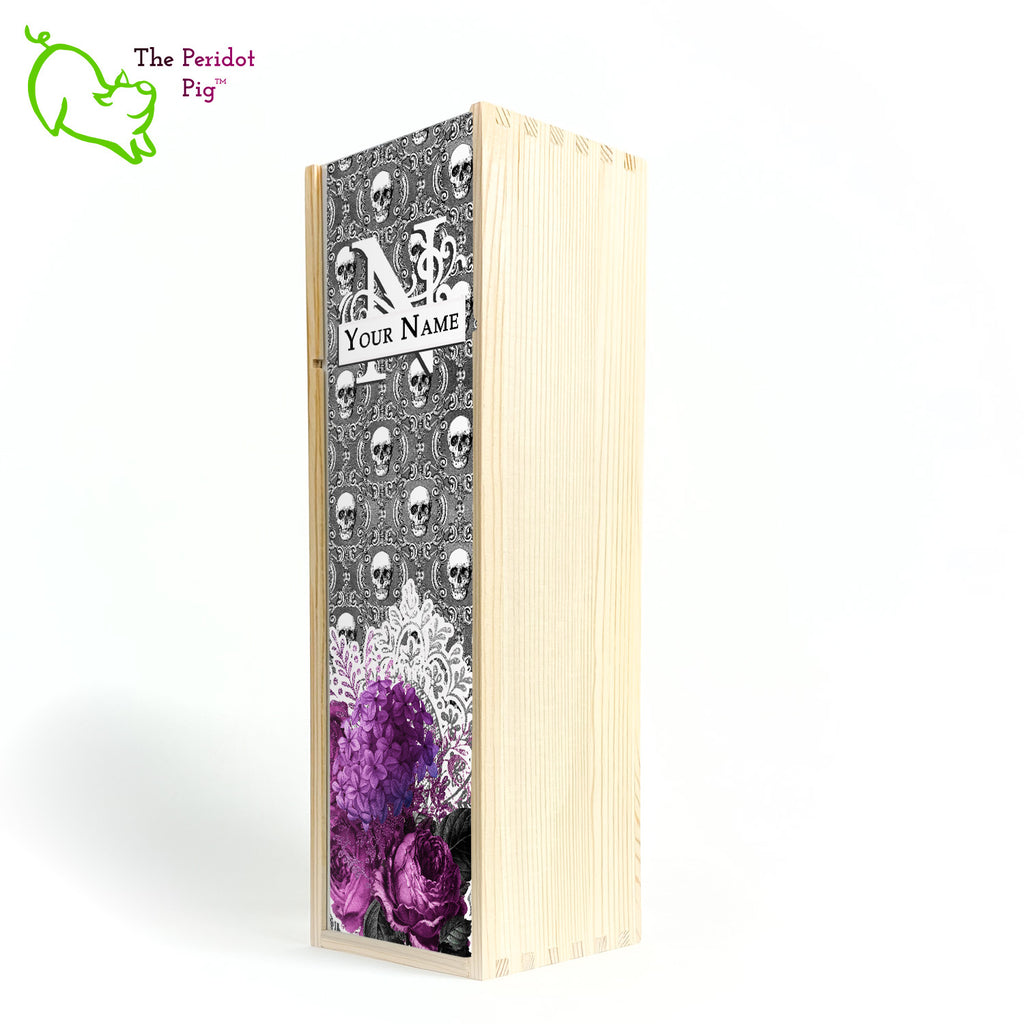 A gift wine box with decorated panel. The front panel is decorated in a glossy, detailed print with a monogram and space for a customized name. This model has a background of Victorian skulls with a bouquet of purple flowers and lace. Front view shown in natural finish.
