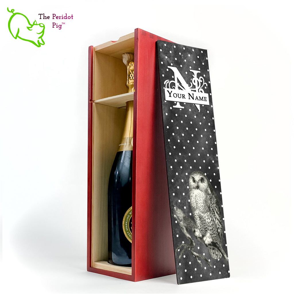 The wine box front panel is decorated in a glossy, detailed print with a white monogram and space for a customized name. This model has a smokey dark gray background with a pattern of white dots. In the foreground is a large black line drawing of an owl. Cherry version showing the interior and a sample bottle of wine.