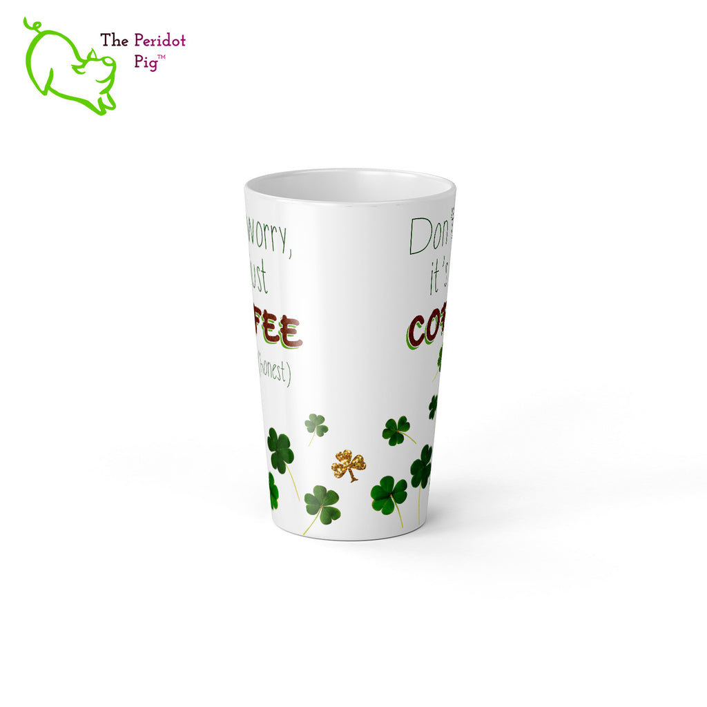 A 17 oz white latte mug. Perfect for an Irish Coffee or a regular cup o'joe. The caption reads, "Don't worry, it's just coffee (honest)" set amid a collection of shamrocks. Center view.