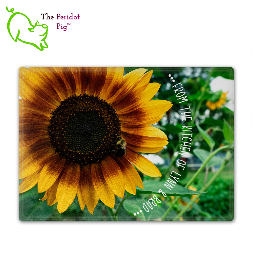 These beautiful tempered glass cutting boards are a wonderful keepsake!  They can be personalized with names, quotes or dates. This one features a huge sunflower with a little honey bee in a vivid and detailed print. The text can wrap around as shown or be formatted in a block if longer. Front view without highlights.
