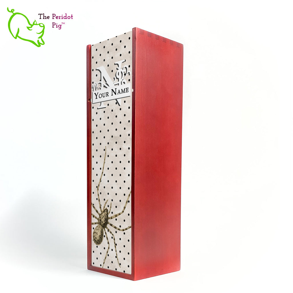 The wine box front panel is decorated in a glossy, detailed print with a white monogram and space for a customized name. This model has a mottled beige background with a pattern of black dots. In the foreground is a large drawing of huge spider. Not for the faint at heart! Cherry version showing front view.