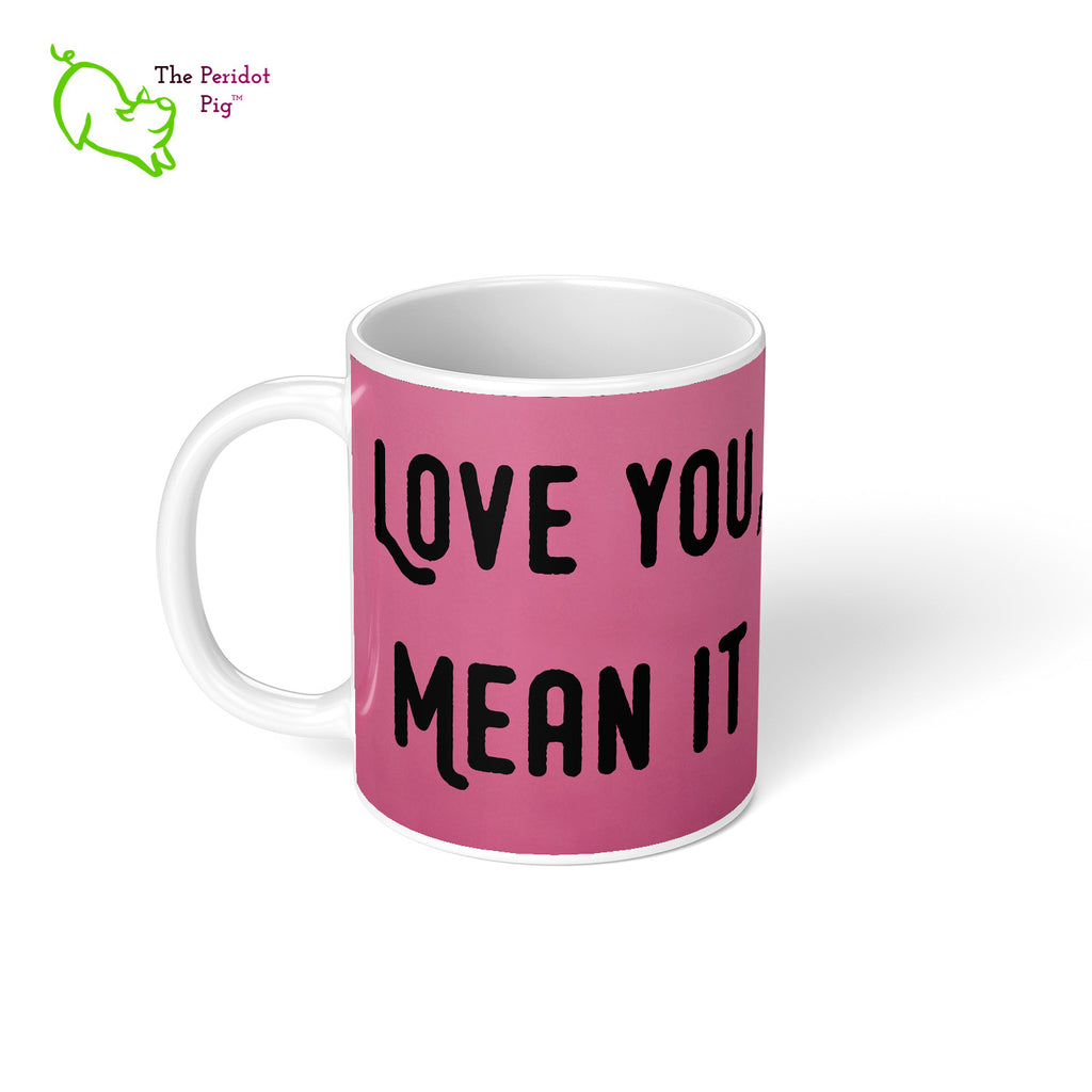 Our 11 oz coffee mug has the printed phrase, "Love You, Mean It" one one side and the raised hand on the other spelling "I love you" in ASL. Left view.