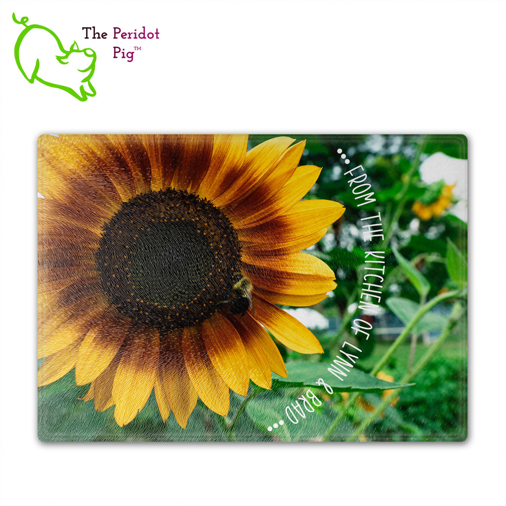 These beautiful tempered glass cutting boards are a wonderful keepsake!  They can be personalized with names, quotes or dates. This one features a huge sunflower with a little honey bee in a vivid and detailed print. The text can wrap around as shown or be formatted in a block if longer. Front view with sample text.