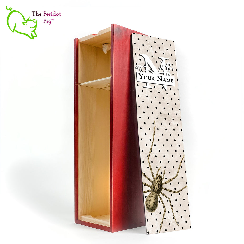 The wine box front panel is decorated in a glossy, detailed print with a white monogram and space for a customized name. This model has a mottled beige background with a pattern of black dots. In the foreground is a large drawing of huge spider. Not for the faint at heart! Cherry version showing the interior.