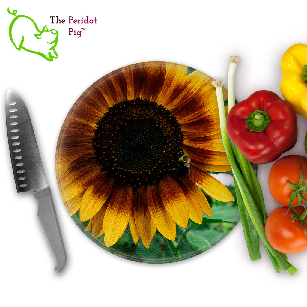 This beautiful tempered glass cutting board is a wonderful keepsake!  This one features a bright yellow sunflower with a cute little honey bee in a vivid and detailed print. Perfect for cutting or using as a serving board! Front view with veggies.