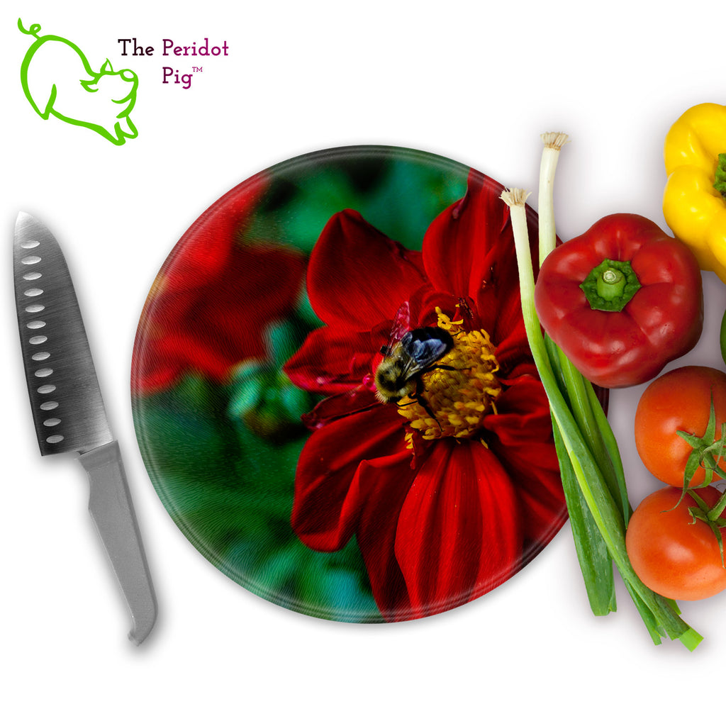 This beautiful tempered glass cutting board is a wonderful keepsake!  This one features bright red flowers with a cute little honey bee in a vivid and detailed print. Perfect for cutting or using as a serving board! Front view with veggies.
