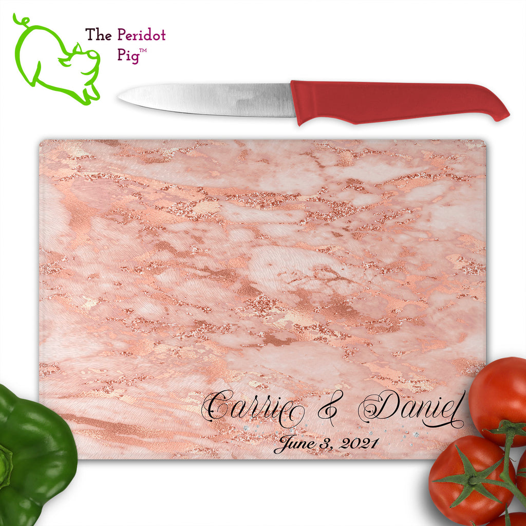 These beautiful tempered glass cutting boards are a wonderful keepsake!  They can be personalized with names, quotes or dates. These feature swirling marbles in rose gold and glitter foil in a vivid and detailed print. We prefer a scrolling script for the personalization in this design. There is also a little bling under the name included too. Front view with sample text and veggies. Style A