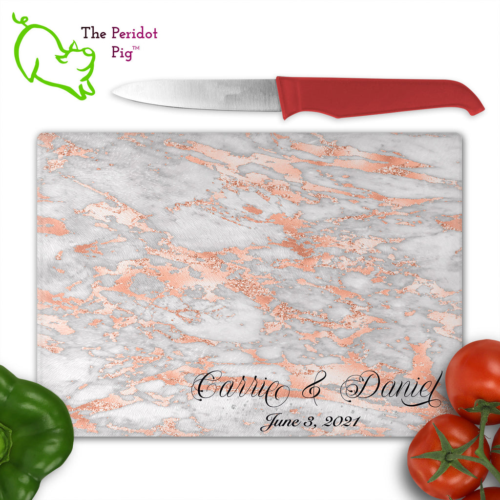 These beautiful tempered glass cutting boards are a wonderful keepsake!  They can be personalized with names, quotes or dates. These feature swirling marbles in rose gold and glitter foil in a vivid and detailed print. We prefer a scrolling script for the personalization in this design. There is also a little bling under the name included too. Front view with sample text and veggies. Style B