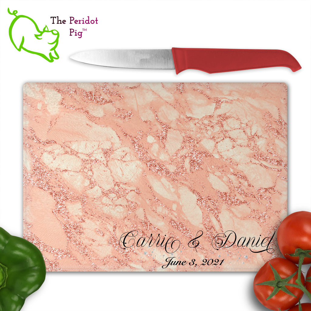 These beautiful tempered glass cutting boards are a wonderful keepsake!  They can be personalized with names, quotes or dates. These feature swirling marbles in rose gold and glitter foil in a vivid and detailed print. We prefer a scrolling script for the personalization in this design. There is also a little bling under the name included too. Front view with sample text with veggies. Style D