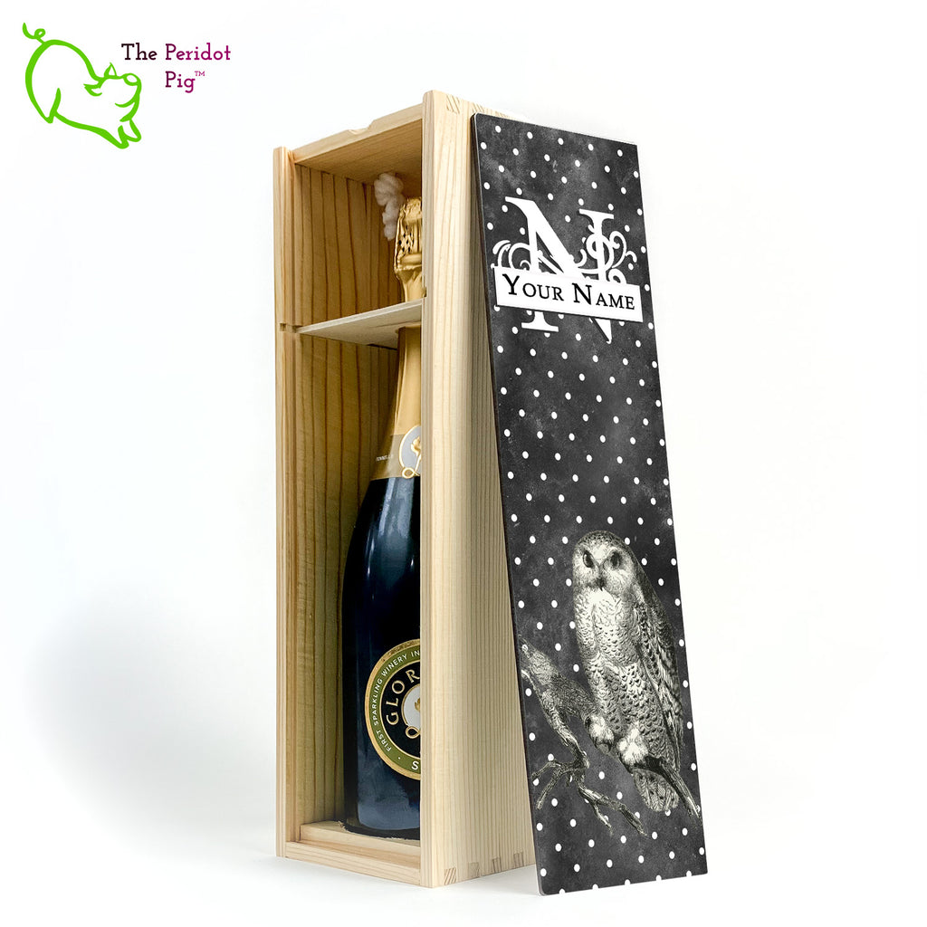 The wine box front panel is decorated in a glossy, detailed print with a white monogram and space for a customized name. This model has a smokey dark gray background with a pattern of white dots. In the foreground is a large black line drawing of an owl. Natural version showing the interior and a sample bottle of wine.