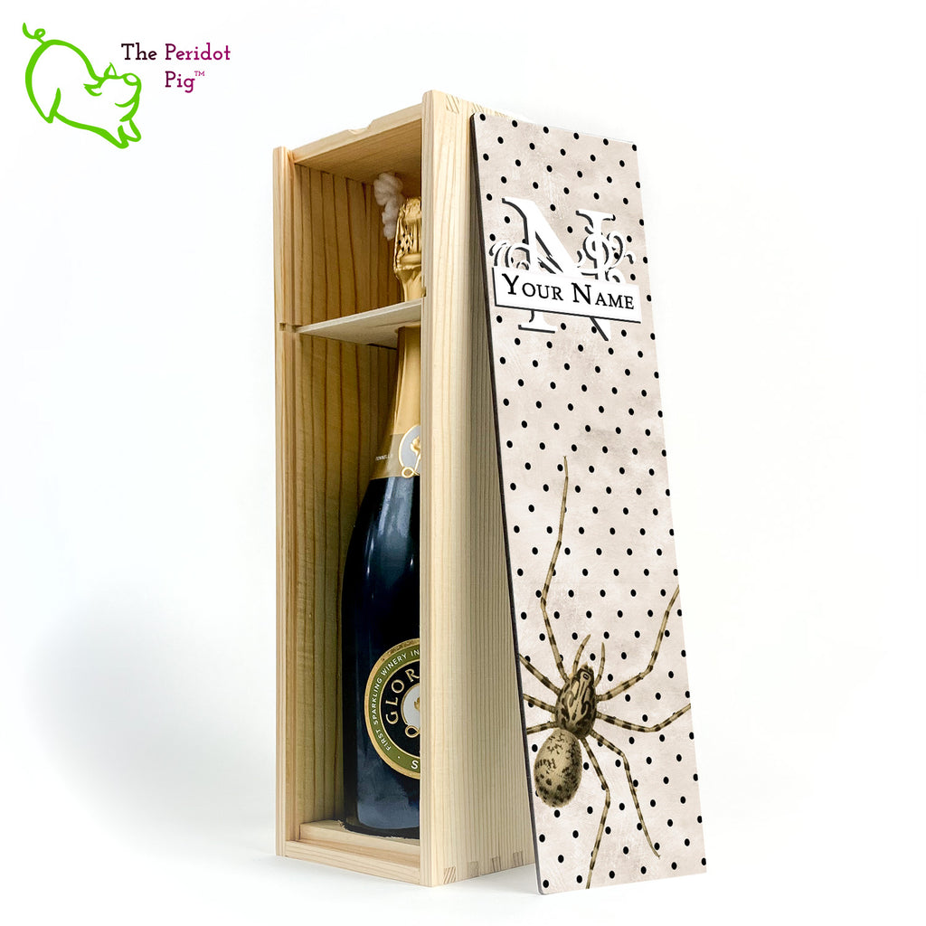 The wine box front panel is decorated in a glossy, detailed print with a white monogram and space for a customized name. This model has a mottled beige background with a pattern of black dots. In the foreground is a large drawing of huge spider. Not for the faint at heart! Natural version showing the interior and a sample bottle of wine.