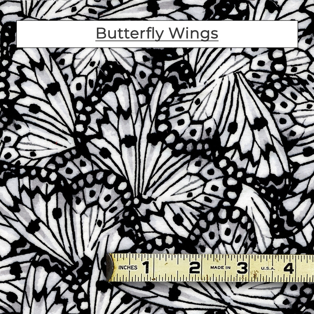 The Butterfly Wings fabric is a mix of black and white with a touch of grey in stylized monarch butterfly wing pattern. 