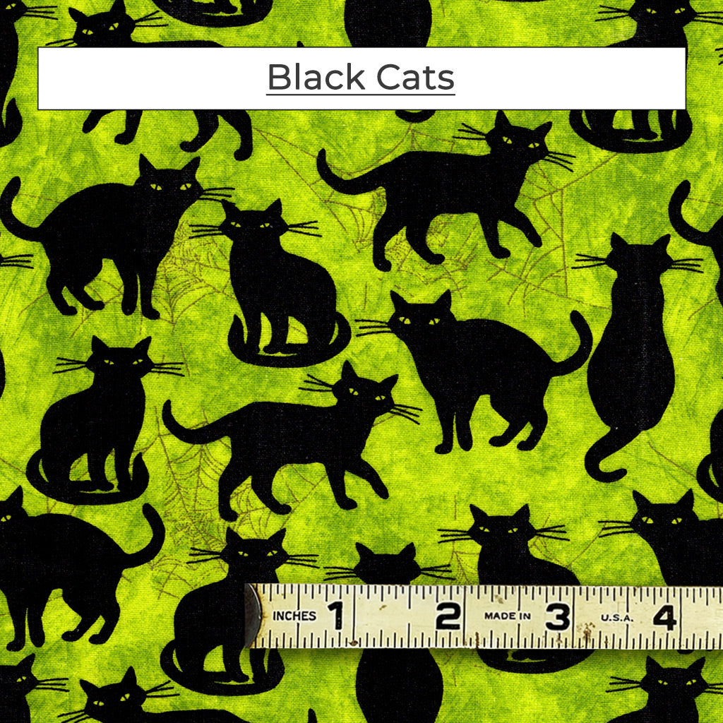 A collection of slinky and stylish black cats set on a bright chartreuse background. with a bit of spider web. Called Black Cats