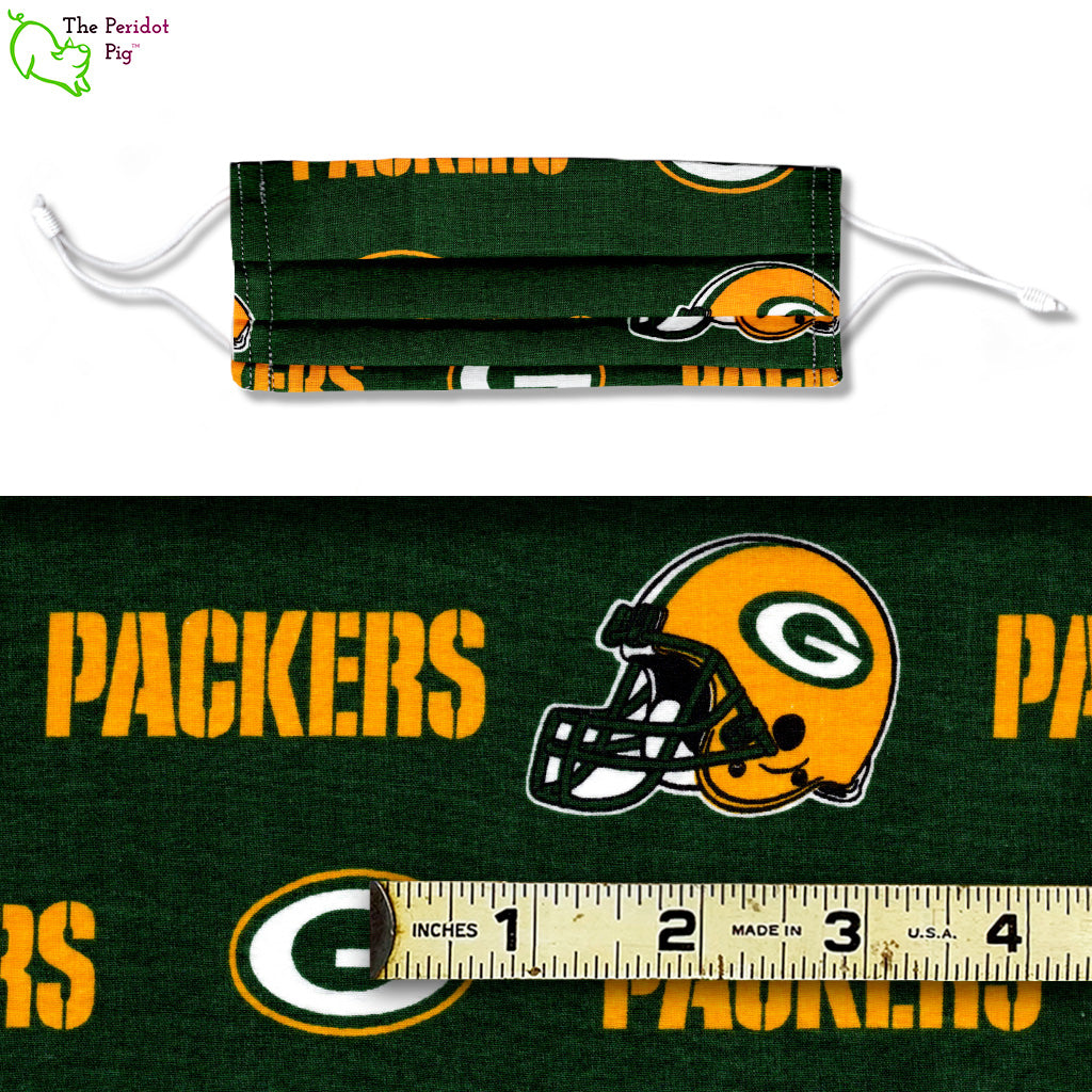 bright green and gold Packers mask. Shown with ruler.