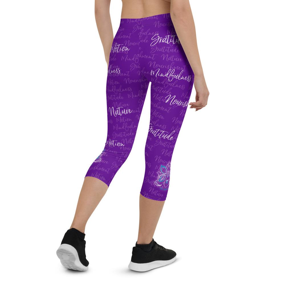 These Kristin Zako capri leggings are filled with her four pillars phrases and topped off with her logo on each side. They are super soft and comfortable. Shown in purple, back view.