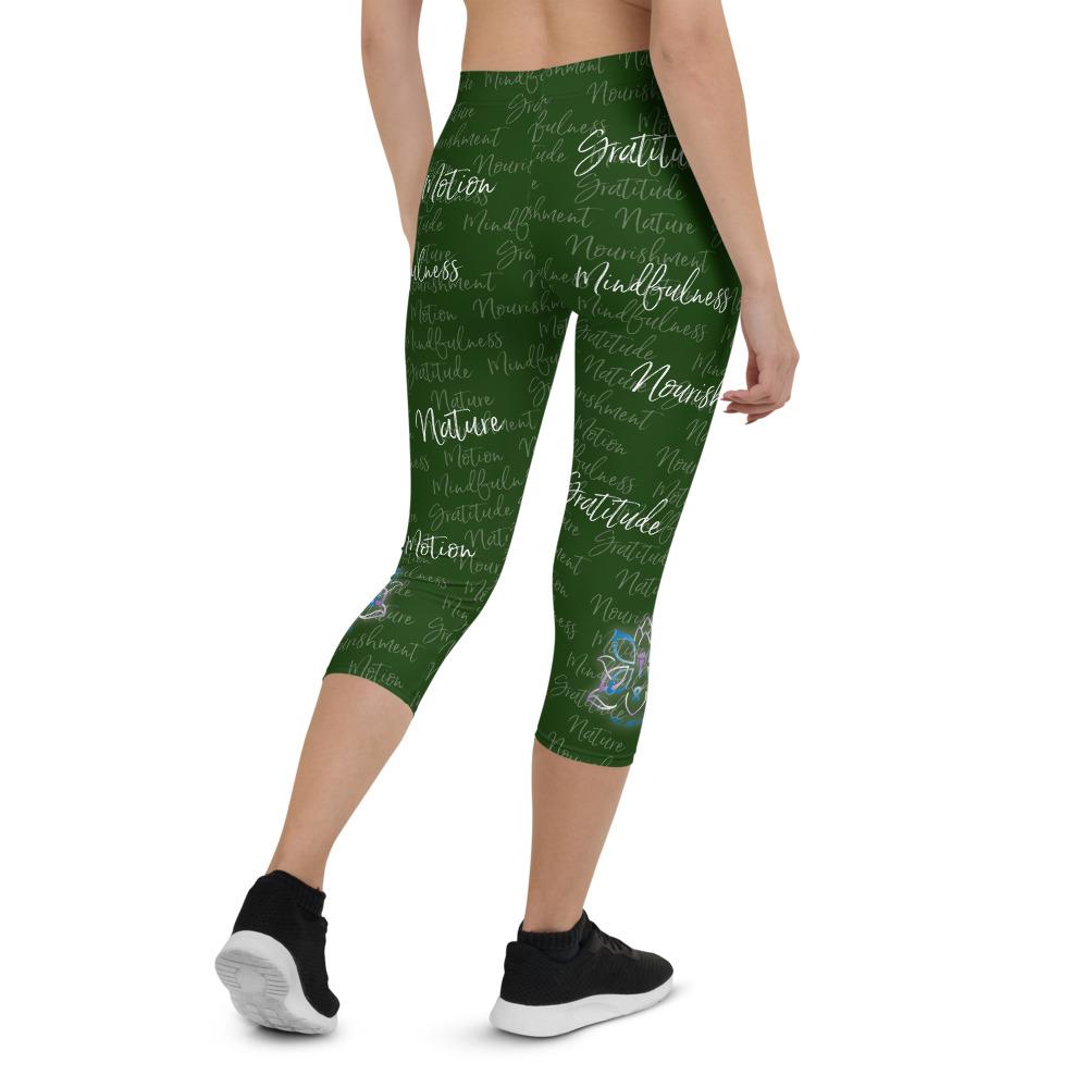 These Kristin Zako capri leggings are filled with her four pillars phrases and topped off with her logo on each side. They are super soft and comfortable. Shown in green, back view.