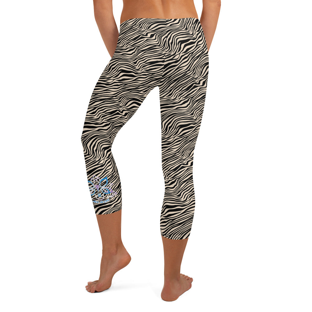 Kristin Zako embodies the "Wild & Free" spirit of her print capri leggings. These are printed in vivid color with a stylized cheetah print. The words, "WILD & FREE" are down the right leg and you'll find Kristin's logo on the lower left leg. Zebra style - back view.