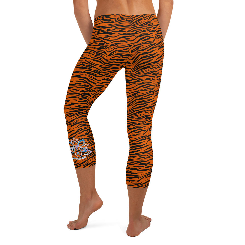 Kristin Zako embodies the "Wild & Free" spirit of her print capri leggings. These are printed in vivid color with a stylized cheetah print. The words, "WILD & FREE" are down the right leg and you'll find Kristin's logo on the lower left leg. Tiger style - back view.