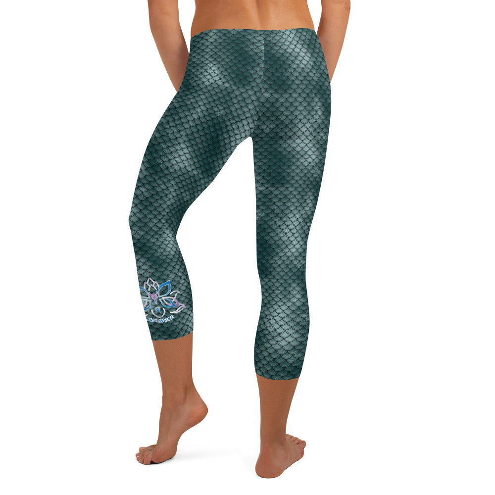 Kristin Zako embodies the "Wild & Free" spirit of her print capri leggings. These are printed in vivid color with a stylized cheetah print. The words, "WILD & FREE" are down the right leg and you'll find Kristin's logo on the lower left leg. Fish scale style - back view.