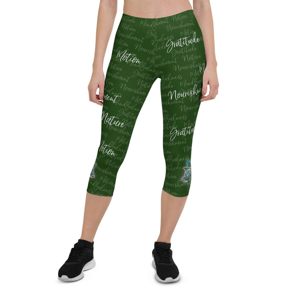 These Kristin Zako capri leggings are filled with her four pillars phrases and topped off with her logo on each side. They are super soft and comfortable. Shown in green, front view.