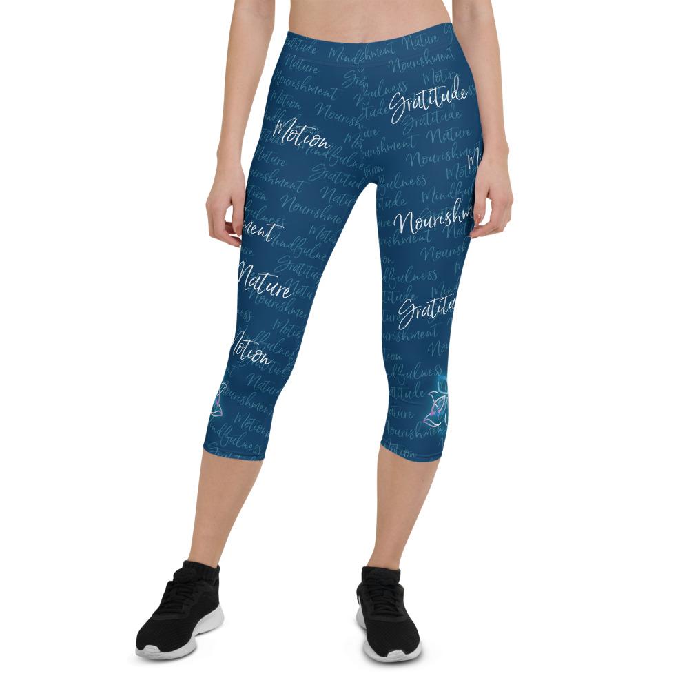 These Kristin Zako capri leggings are filled with her four pillars phrases and topped off with her logo on each side. They are super soft and comfortable. Shown in blue, front view.