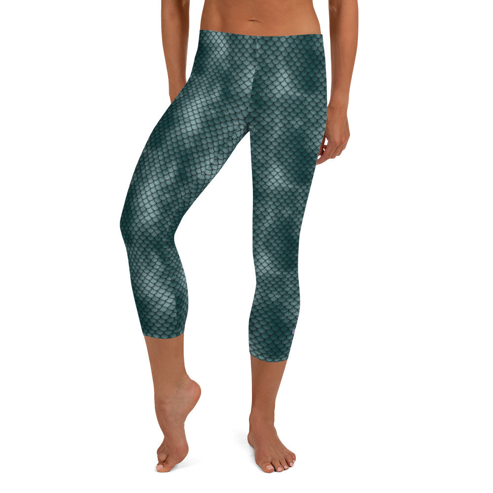Kristin Zako embodies the "Wild & Free" spirit of her print capri leggings. These are printed in vivid color with a stylized cheetah print. The words, "WILD & FREE" are down the right leg and you'll find Kristin's logo on the lower left leg. Fish scale style - Front view.