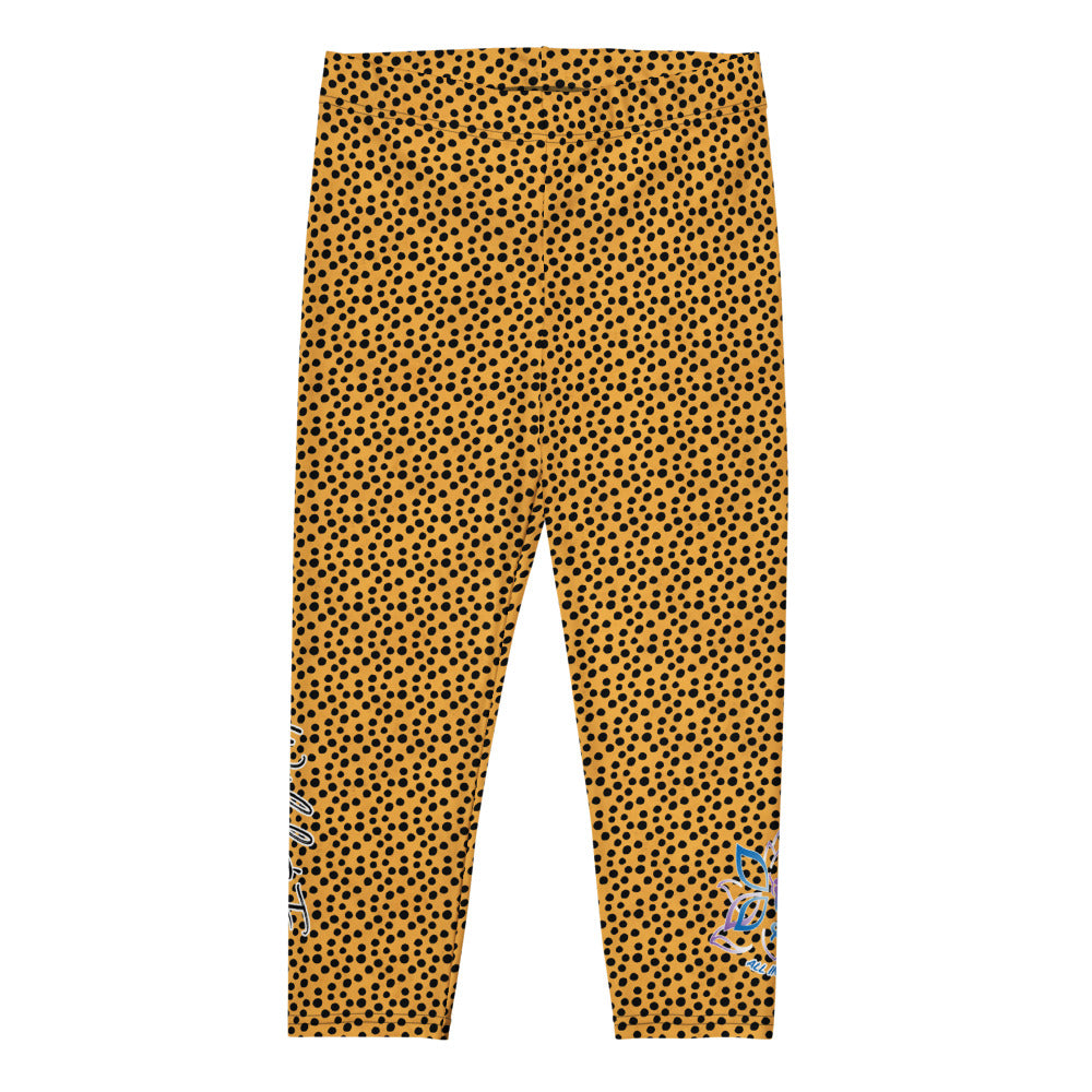 Kristin Zako embodies the "Wild & Free" spirit of her print capri leggings. These are printed in vivid color with a stylized cheetah print.  The words, "WILD & FREE" are down the right leg and you'll find Kristin's logo on the lower left leg. Cheetah style - Flat view.
