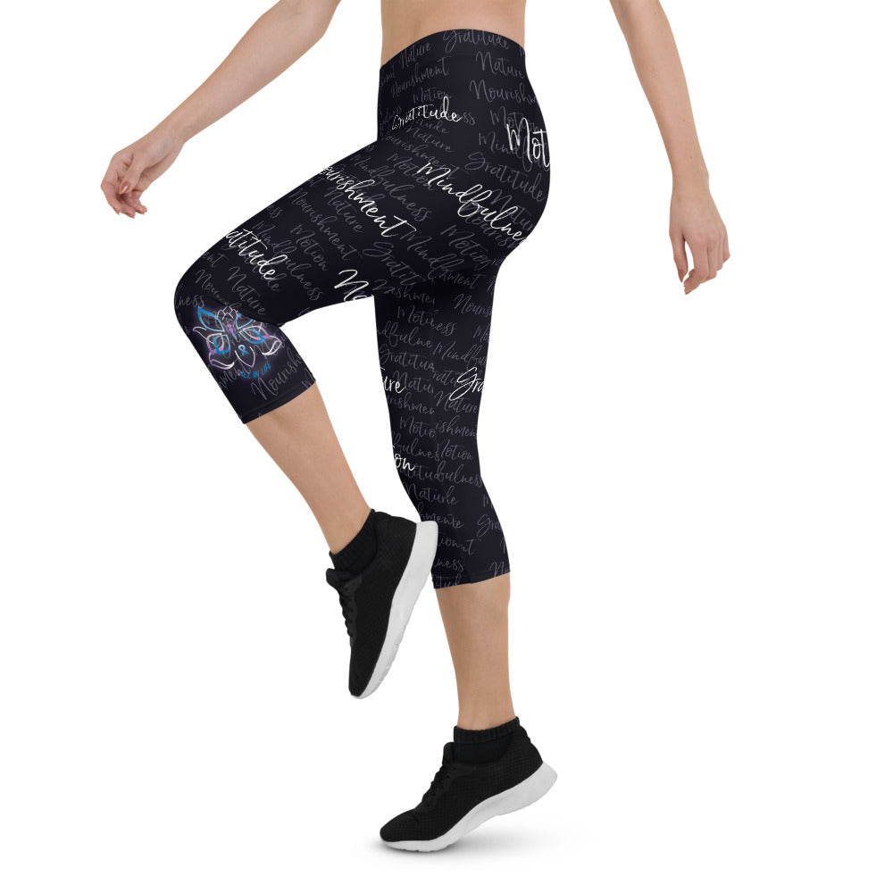 These Kristin Zako capri leggings are filled with her four pillars phrases and topped off with her logo on each side. They are super soft and comfortable. Shown in black, left view.