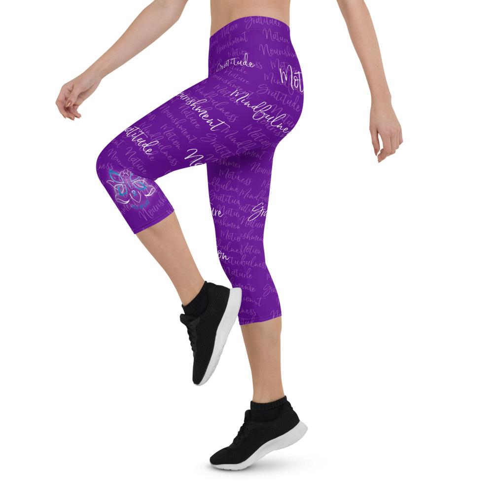 These Kristin Zako capri leggings are filled with her four pillars phrases and topped off with her logo on each side. They are super soft and comfortable. Shown in purple, left view.