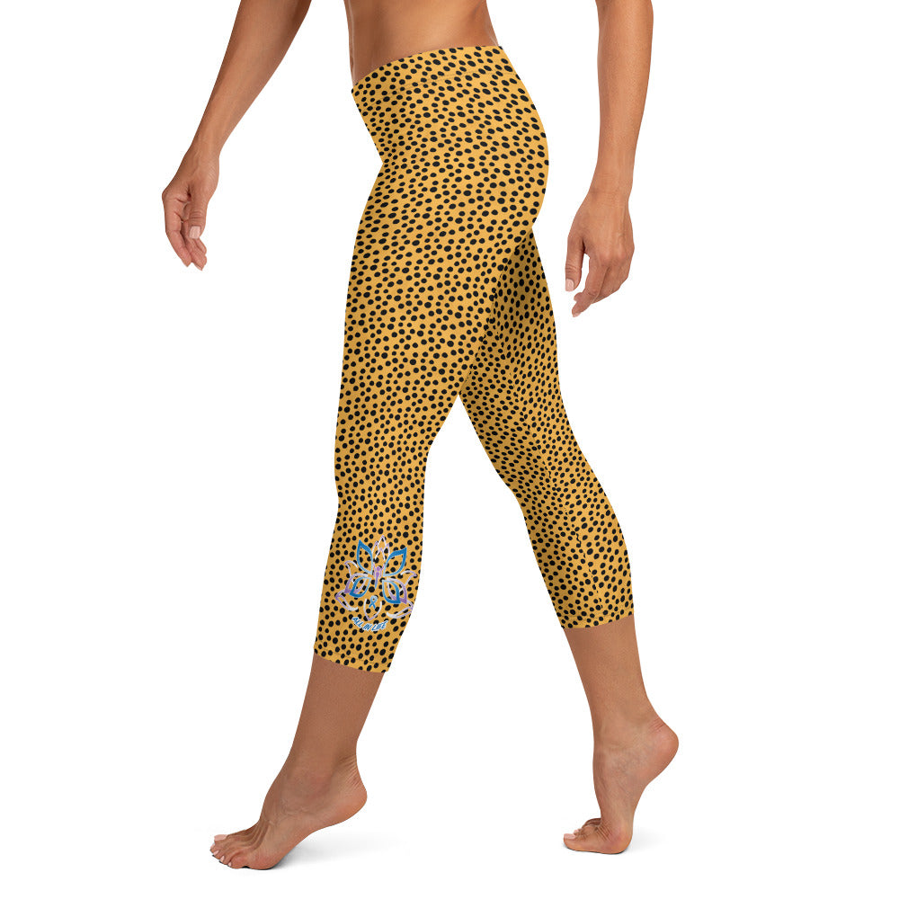 Kristin Zako embodies the "Wild & Free" spirit of her print capri leggings. These are printed in vivid color with a stylized cheetah print.  The words, "WILD & FREE" are down the right leg and you'll find Kristin's logo on the lower left leg. Cheetah style -Left view.