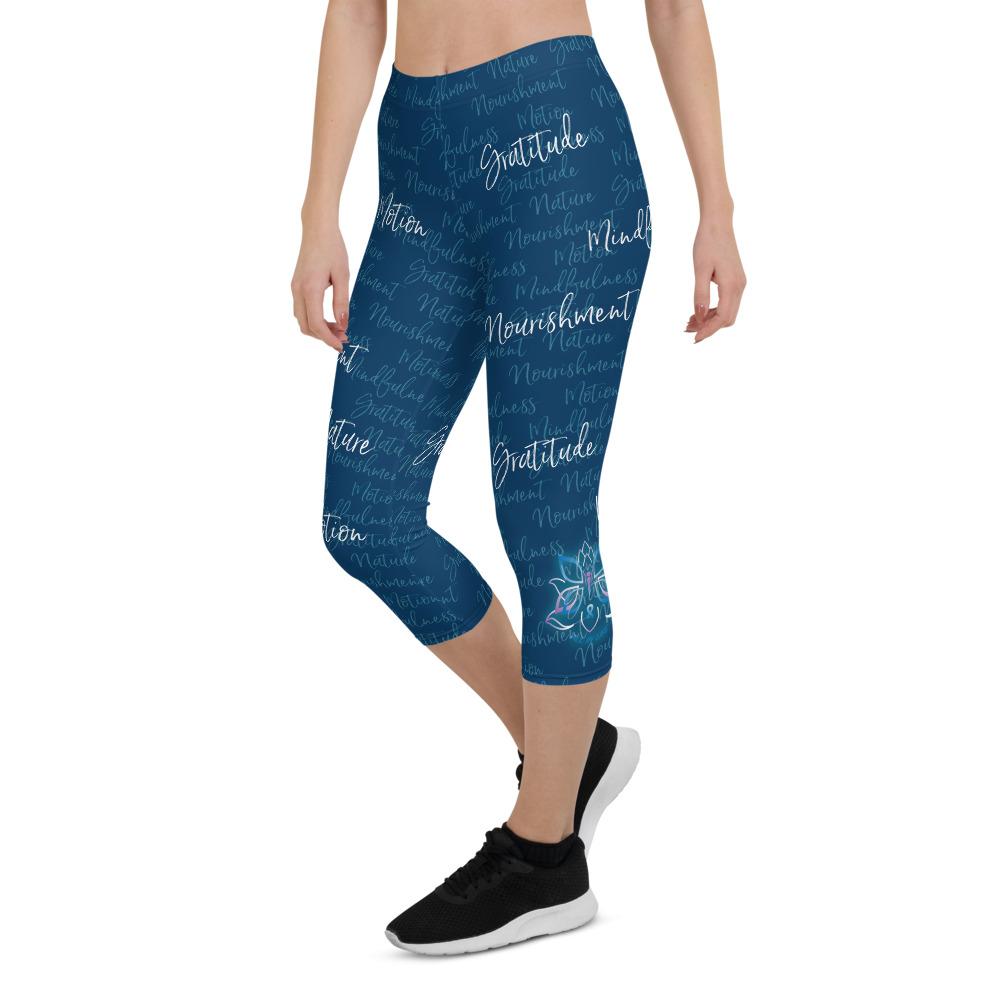 These Kristin Zako capri leggings are filled with her four pillars phrases and topped off with her logo on each side. They are super soft and comfortable. Shown in blue, front left view.