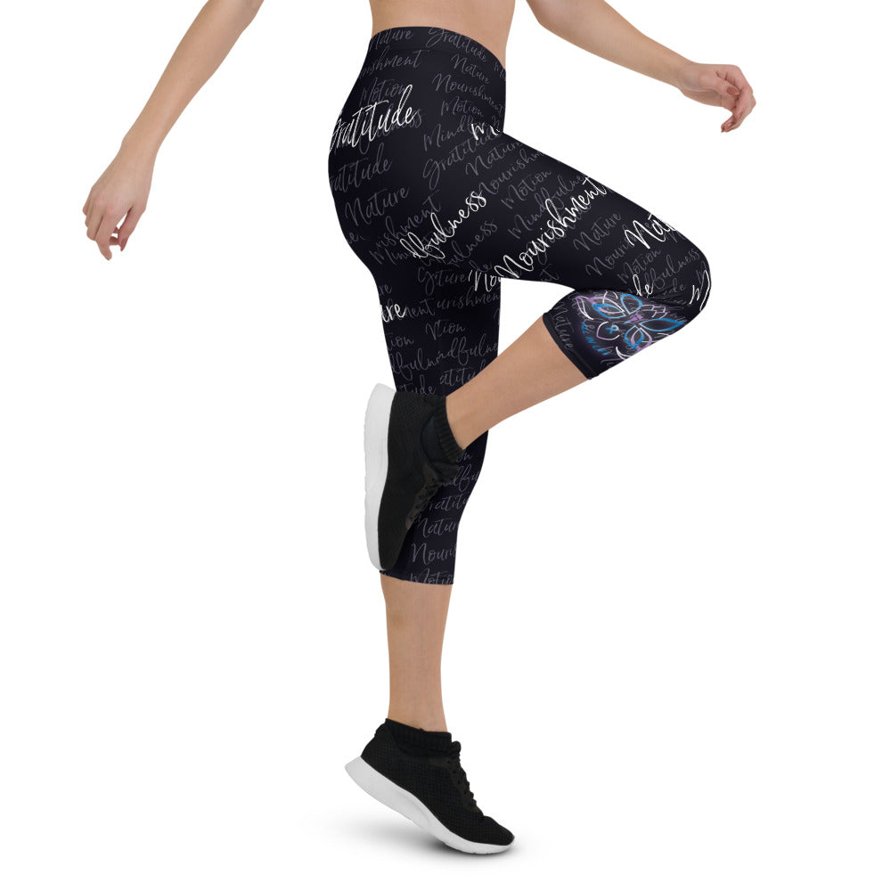 These Kristin Zako capri leggings are filled with her four pillars phrases and topped off with her logo on each side. They are super soft and comfortable. Shown in black, right view.