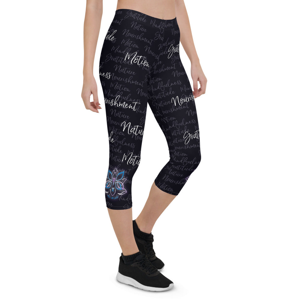 These Kristin Zako capri leggings are filled with her four pillars phrases and topped off with her logo on each side. They are super soft and comfortable. Shown in black, front right  view.