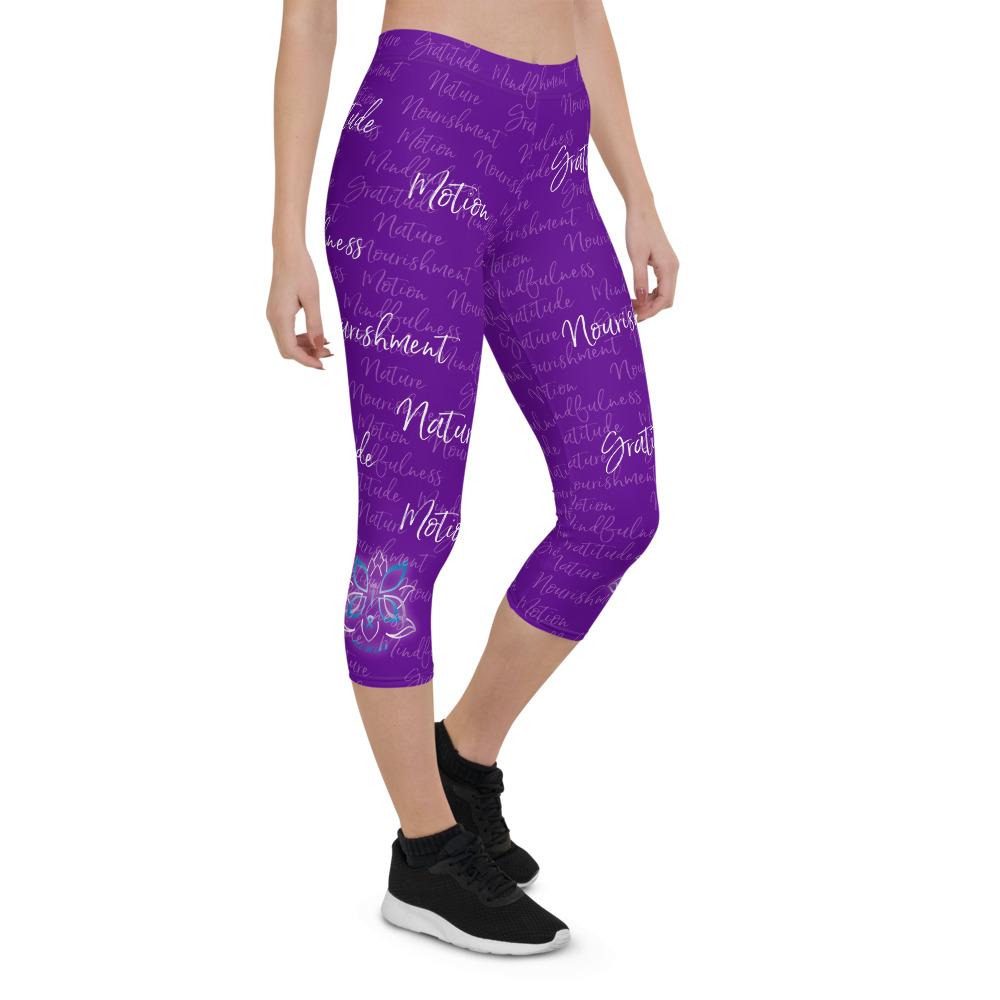 These Kristin Zako capri leggings are filled with her four pillars phrases and topped off with her logo on each side. They are super soft and comfortable. Shown in purple, front right view.