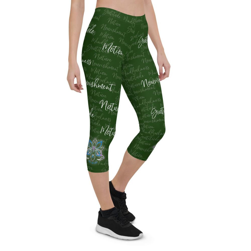 These Kristin Zako capri leggings are filled with her four pillars phrases and topped off with her logo on each side. They are super soft and comfortable. Shown in green, front right view.
