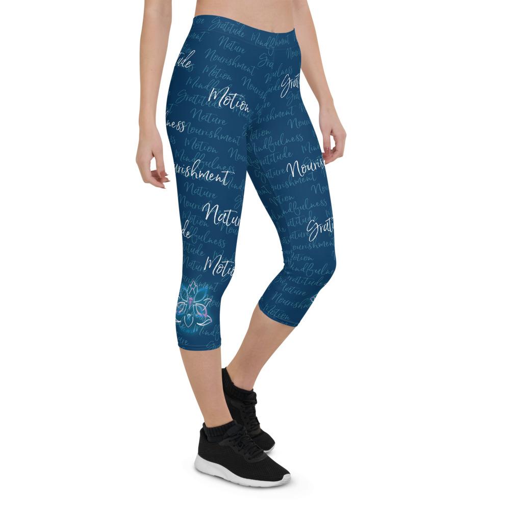 These Kristin Zako capri leggings are filled with her four pillars phrases and topped off with her logo on each side. They are super soft and comfortable. Shown in blue, front right  view.