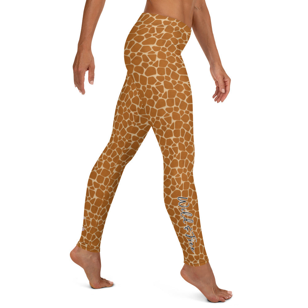 Kristin Zako embodies the "Wild & Free" spirit of her giraffe print leggings. These are printed in vivid color with a stylized giraffe print.  The words, "WILD & FREE" are down the right leg and you'll find Kristin's logo on the lower left leg. Right view.
