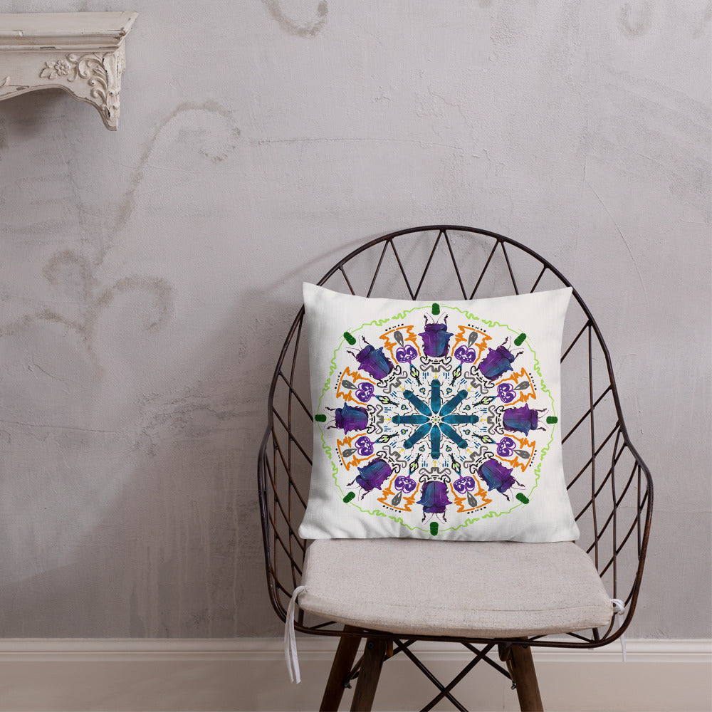 A colorful mandala of beetles graces this white pillow and is availble in either 18"x18" or 22"x22" sizes. The image is printed on both the front and back. The larger beetle has shades of violet and blue. Shown in size 18x18 on a chair.