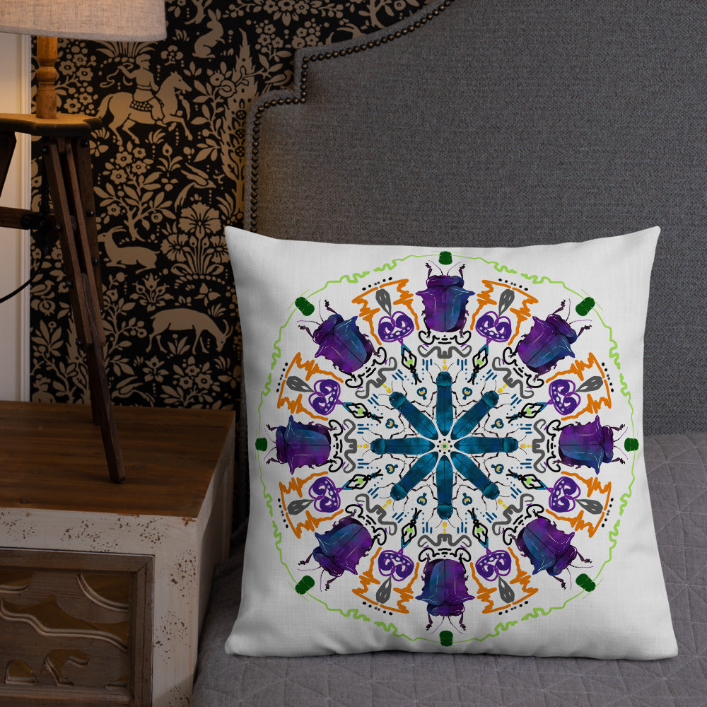 A colorful mandala of beetles graces this white pillow and is availble in either 18"x18" or 22"x22" sizes. The image is printed on both the front and back. The larger beetle has shades of violet and blue. Shown in size 22x22 on a bed