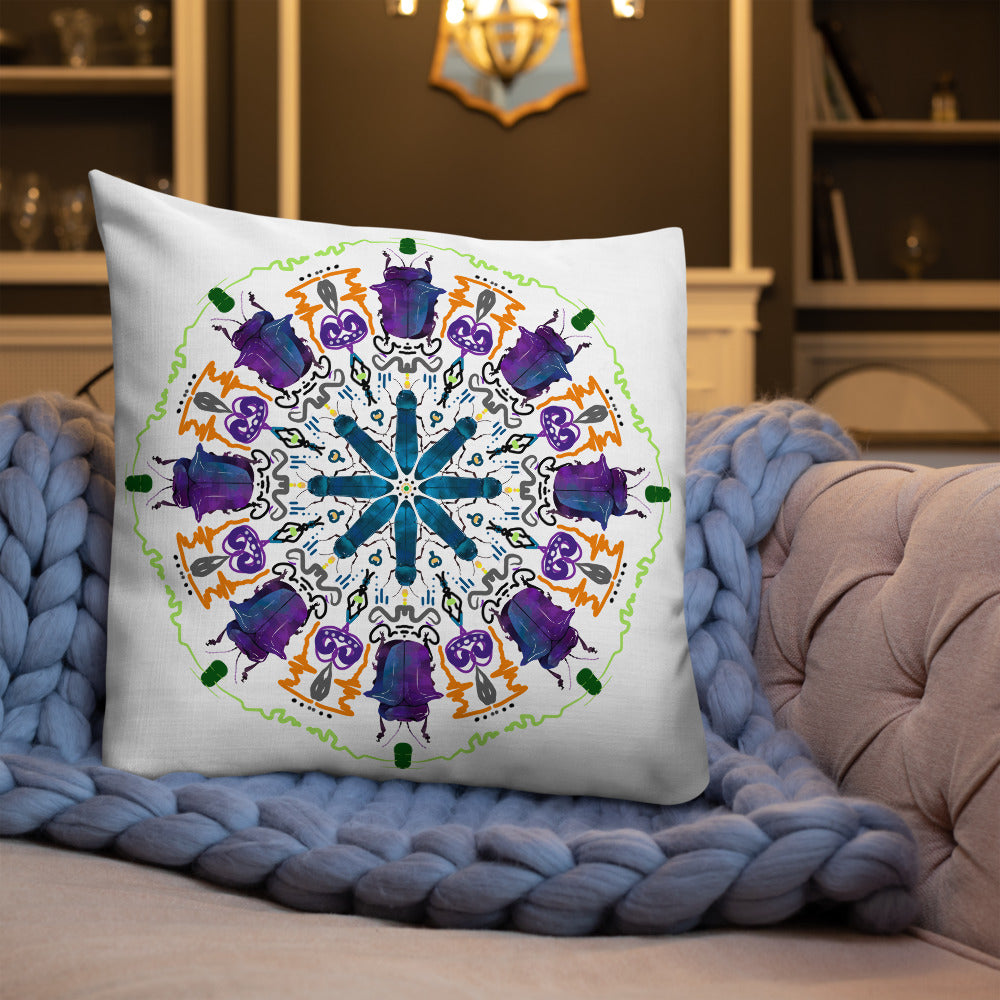 A colorful mandala of beetles graces this white pillow and is availble in either 18"x18" or 22"x22" sizes. The image is printed on both the front and back. The larger beetle has shades of violet and blue. Shown in size 22x22 on a couch