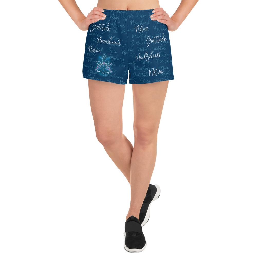 These athletic women's short shorts are so comfy and made from such a versatile fabric that you won't feel out of place at any sports event. The Kristin Zako print is filled with her four pillars phrases and topped off with her logo on the front right leg. Shown in blue. Front view.
