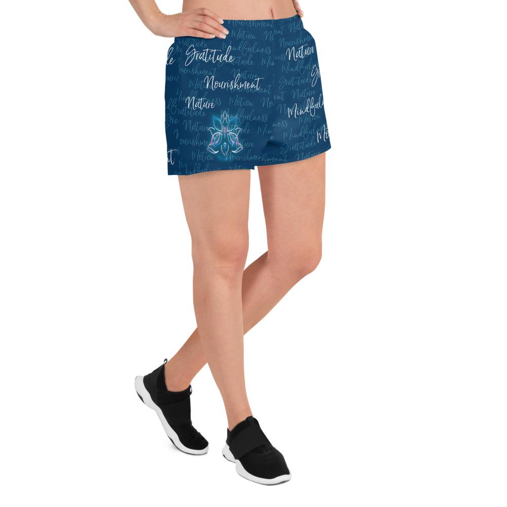 These athletic women's short shorts are so comfy and made from such a versatile fabric that you won't feel out of place at any sports event. The Kristin Zako print is filled with her four pillars phrases and topped off with her logo on the front right leg. Shown in blue. Right view.